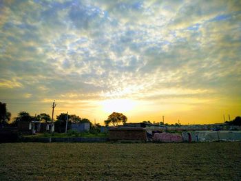 Scenic view of field against sky during sunset