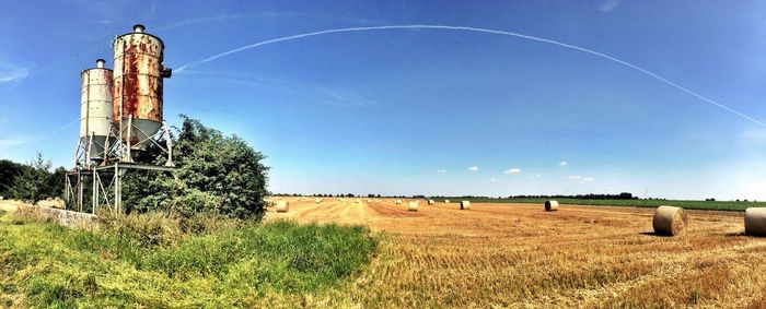 Scenic view of rural landscape against blue sky