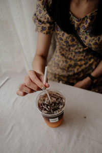 Midsection of woman holding ice cream