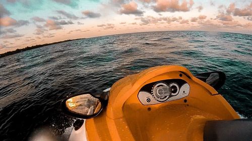 Close-up of boat in sea against sky