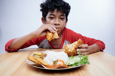 Portrait of young woman eating food