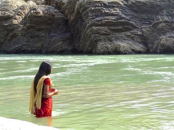 Woman standing in ganges river