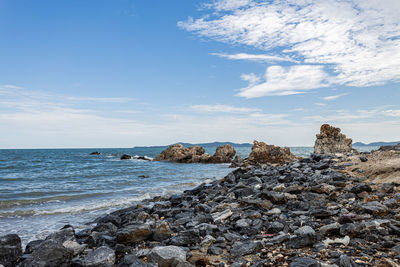 Rocks on beach against sky