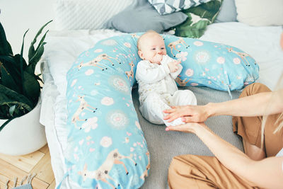 High angle view of baby sleeping on bed at home