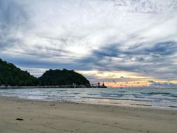 Scenic view of beach against sky during sunset