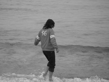 Rear view of boy on beach
