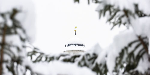 Close-up of cross against sky during winter