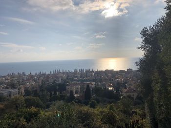 High angle view of buildings and sea against sky