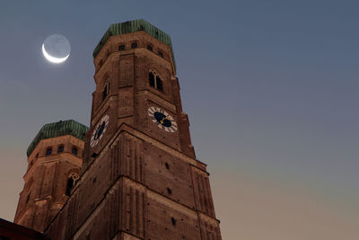 Low angle view of church against clear sky and moon