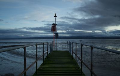 Pier over sea against sky