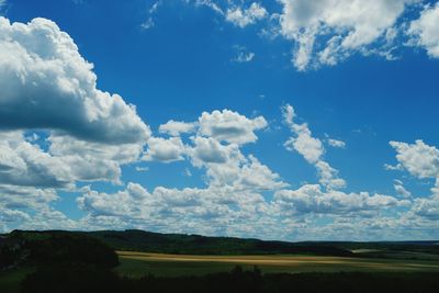 Scenic view of field against blue sky