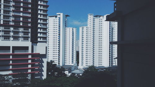 Buildings in city against sky