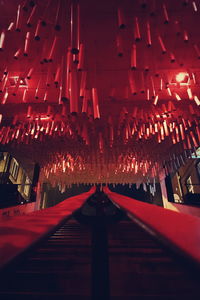 Low angle view of illuminated lanterns in temple at night