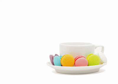 Close-up of multi colored candies against white background