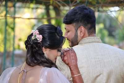 Rear view of couple holding hands