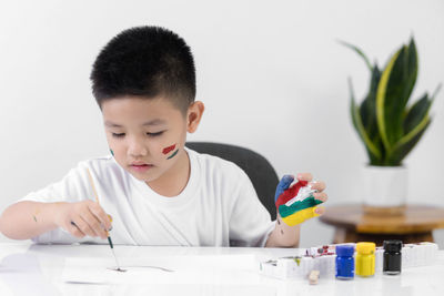 Boy looking at camera on table