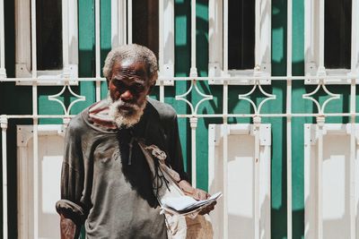 Full length of man standing against wall