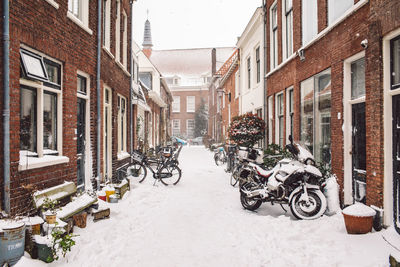 Street amidst buildings in city during winter