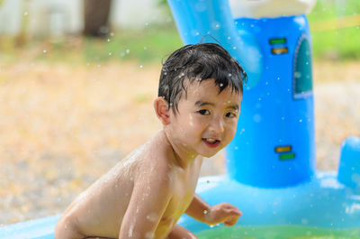 Portrait of boy playing in swimming pool