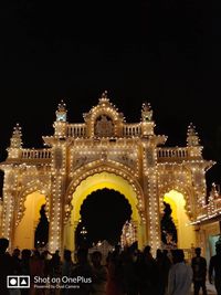 Group of people in front of illuminated building at night