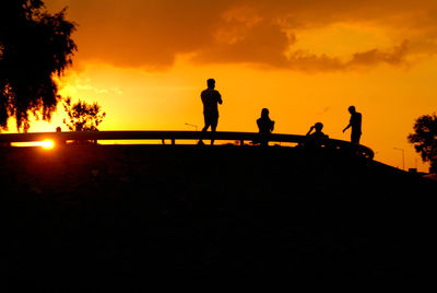 Silhouette people at sunset