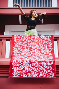 Woman standing in balcony at railing