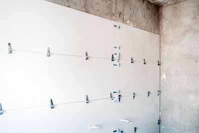 Construction site. white tiles on bathroom with separator and leveling during works. home renovation