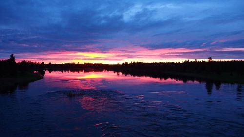 Scenic view of lake against romantic sky at sunset