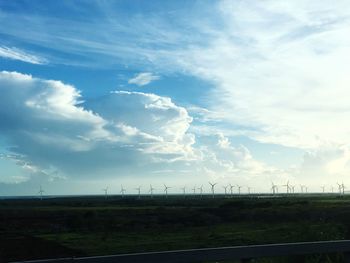 Scenic view of field against cloudy sky