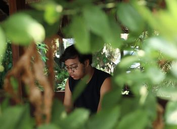 A man wearing black shirt is sitting in the park