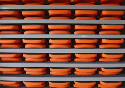 Full frame shot of orange trays in shelf