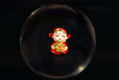 Close-up of toy figurine against black background