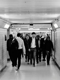 People walking on railroad station platform