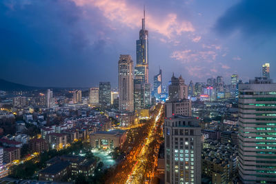 Illuminated cityscape against sky at night