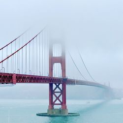 View of suspension bridge in foggy weather