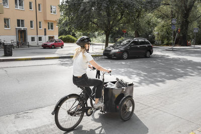 Woman cycling cargo bike