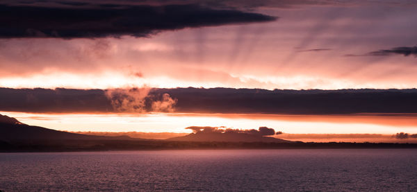 Scenic view of sea against romantic sky at sunset