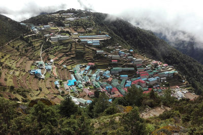 High angle view of trees and houses against sky