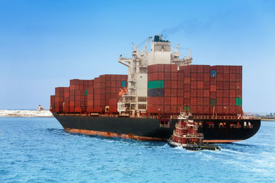 View of ship in sea against clear blue sky