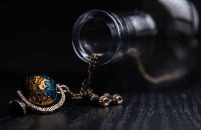 Close-up of metal on table against black background