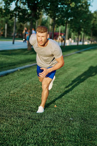 Full length of boy playing with ball on field