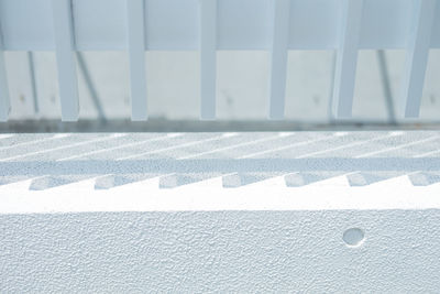 High angle view of white shadow on wall