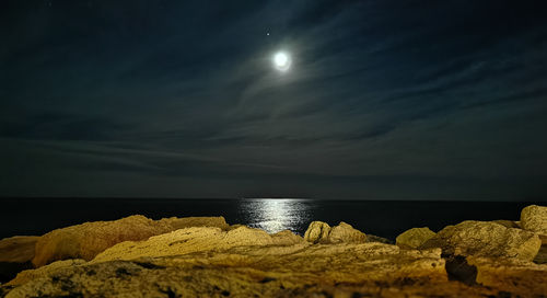 Scenic view of sea against sky at night