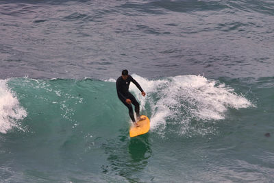 Full length of man surfing in sea