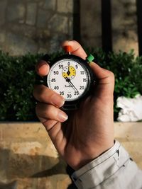 Close-up of person hand holding clock