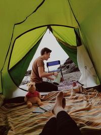 Low section of woman sitting in tent