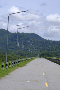 Road by street against sky