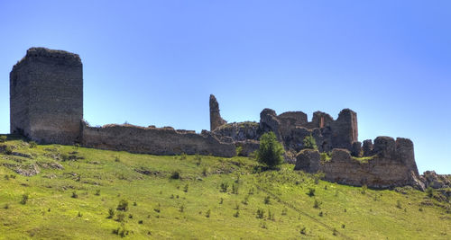 Ruins of fort against clear blue sky