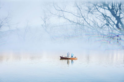 Men sitting on boat in water