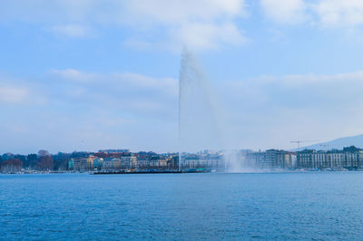 Panoramic view of buildings by sea against sky